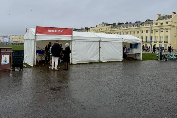Helpdesk tent on one of Brighton's seafront squares